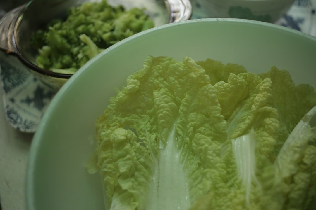 Step-by-step process of making sauerkraut showing cabbage being sliced, massaged with salt, packed into a jar, and weighted down with glass weight